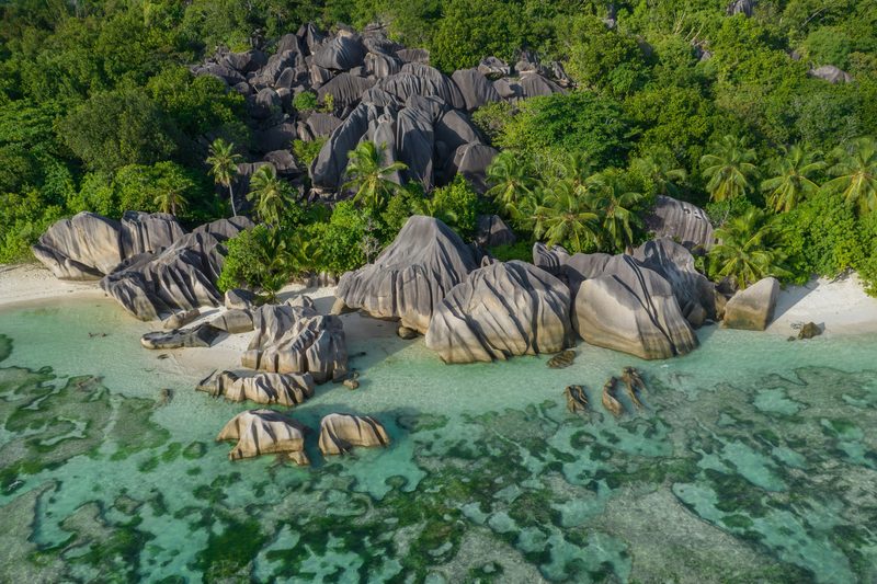 Aerial view of dramatic granite boulders and turquoise water in the Seychelles